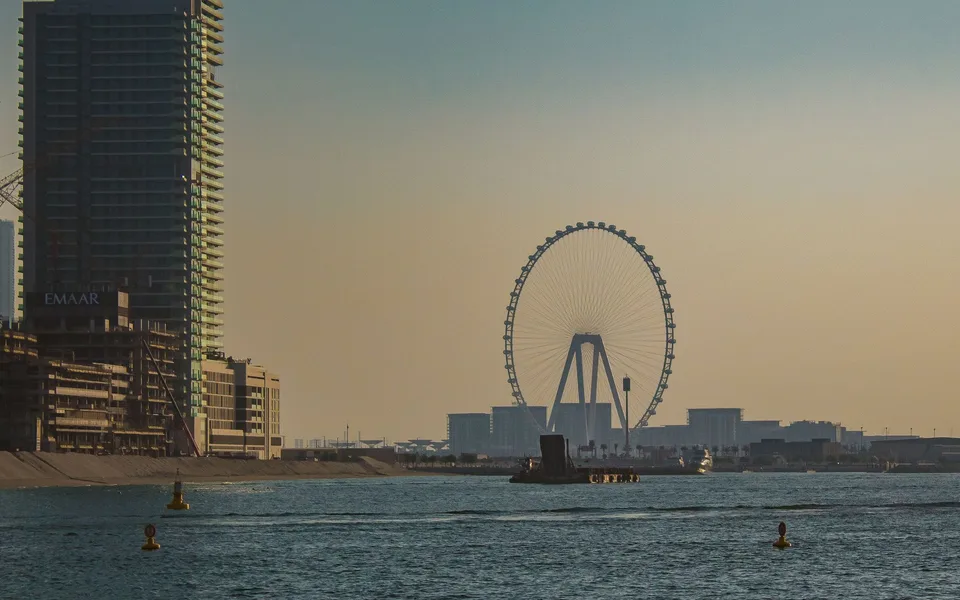 Skyline von Dubai mit Riesenrad bei Sonnenuntergang